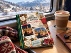 Holiday photo book on an Alpine train table with hot chocolate and a knitted scarf