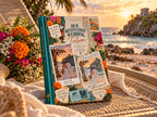Couples travel memory book on a woven daybed with marigold flowers and the Tulum ruins at sunset